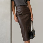 Women's High Waisted Faux Leather Midi Skirt - Palomine — velloura-elegant-sculpted-faux-leather-midi-skirt_lifestyle_leaning_wall_04.webp