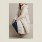 Women's Cozy Longline Puffer Jacket – Clover — variant_lifestyle_v_b7efc41a3d__langley-cozy-longline-puffer-jacket-for-women_lifestyle_seated_pause_04.webp