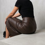 Women's High Waisted Faux Leather Midi Skirt - Palomine — velloura-elegant-sculpted-faux-leather-midi-skirt_lifestyle_seated_pause_03.webp